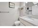 Clean bathroom featuring white walls, a mirror, and a sink with a large bright faucet at 17427 E Rice Cir # C, Aurora, CO 80015
