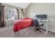 Bright bedroom featuring a large window, neutral walls, and a dedicated workspace at 17427 E Rice Cir # C, Aurora, CO 80015