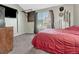 Bright bedroom showcasing a large window, a mounted TV, neutral walls, and hardwood floors at 17427 E Rice Cir # C, Aurora, CO 80015