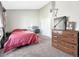 Spacious bedroom with a bright window, neutral walls, dedicated workspace, and an ample dresser at 17427 E Rice Cir # C, Aurora, CO 80015