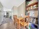 Dining room with bookshelf, wooden table and chairs. Adjacent is a cozy living room space at 17427 E Rice Cir # C, Aurora, CO 80015