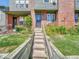 A welcoming exterior view highlights the front steps and wooden retaining wall at 17427 E Rice Cir # C, Aurora, CO 80015