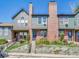 Attractive multi-level townhome with brick chimneys, garden beds, and a classic, traditional design at 17427 E Rice Cir # C, Aurora, CO 80015
