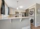 Compact kitchen features modern stainless steel appliances and sleek, neutral finishes at 17427 E Rice Cir # C, Aurora, CO 80015