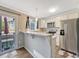 Bright kitchen featuring stainless steel appliances and access to the patio via a sliding glass door at 17427 E Rice Cir # C, Aurora, CO 80015
