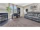 Welcoming living room showcasing a modern gray sofa, decorative art, and cozy fireplace at 17427 E Rice Cir # C, Aurora, CO 80015