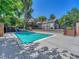 Community pool area with chairs, a deck, and lush landscaping, perfect for summer relaxation and fun at 17427 E Rice Cir # C, Aurora, CO 80015