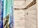 Shower with marble tiling, neutral gray highlights and built-in shelves at 17427 E Rice Cir # C, Aurora, CO 80015