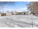 Expansive snow-covered backyard with a detached garage, offering ample outdoor space and potential at 757 S Wheeling St, Aurora, CO 80012