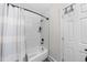 Clean bathroom featuring a shower/tub combo with tiled walls and a stylish shower curtain at 757 S Wheeling St, Aurora, CO 80012