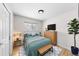 Inviting bedroom with a cozy bed, wood floors, a TV, and a bright window view at 757 S Wheeling St, Aurora, CO 80012
