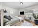 Serene bedroom featuring soft bedding, a window with natural light, and sleek wooden furniture at 757 S Wheeling St, Aurora, CO 80012
