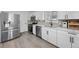 Modern kitchen featuring stainless steel appliances, white cabinetry, quartz countertops, and stylish backsplash at 757 S Wheeling St, Aurora, CO 80012