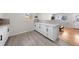 Spacious kitchen with white cabinets, gray backsplash, and stainless-steel appliances with modern countertops at 757 S Wheeling St, Aurora, CO 80012
