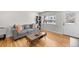 Comfortable living room featuring hardwood floors, a cozy sofa, and a large window offering natural light at 757 S Wheeling St, Aurora, CO 80012