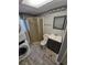 Tiled bathroom features stall shower with glass door, toilet, and sink at 1962 S Ivory Way, Aurora, CO 80013