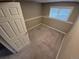 Bedroom with neutral carpet, trim, a window, and a door at 1962 S Ivory Way, Aurora, CO 80013