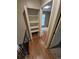Hallway featuring hardwood floors, access to bedroom and small closet at 1962 S Ivory Way, Aurora, CO 80013