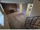 Cozy living room with a brick fireplace, carpet, and nearby staircase and laundry room at 1962 S Ivory Way, Aurora, CO 80013