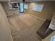 Bright living room with neutral carpet, fireplace, ceiling fan, and access to the kitchen and backyard at 1962 S Ivory Way, Aurora, CO 80013