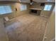 Spacious living room with neutral carpet, fireplace, and multiple windows allowing for ample natural light at 1962 S Ivory Way, Aurora, CO 80013