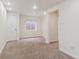 Finished basement space with neutral carpet and white trim at 11642 Moline Ct, Commerce City, CO 80640