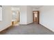 Large bedroom with carpeted floor leading to an ensuite bathroom at 11642 Moline Ct, Commerce City, CO 80640