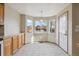 Breakfast nook with tile floors, wood cabinets, and a bay window at 11642 Moline Ct, Commerce City, CO 80640