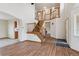 Open foyer with hardwood floors, a staircase, and views to other rooms at 11642 Moline Ct, Commerce City, CO 80640