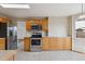 Kitchen featuring light wood cabinets and stainless steel appliances at 11642 Moline Ct, Commerce City, CO 80640