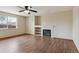 Bright living room featuring a cozy fireplace and large window for natural light at 11642 Moline Ct, Commerce City, CO 80640