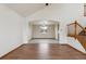 Spacious living room featuring hardwood floors and an arched doorway at 11642 Moline Ct, Commerce City, CO 80640