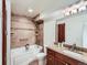 Tiled bathroom showcasing a shower over tub combination, granite-topped vanity, and recessed lighting at 10251 W 44Th Ave # 8-102, Wheat Ridge, CO 80033