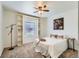 Comfortable bedroom featuring built-in shelving, neutral carpet, and a ceiling fan, perfect for relaxation at 10251 W 44Th Ave # 8-102, Wheat Ridge, CO 80033