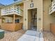 Exterior of a condominium building with wood siding, a stairway to the second story, and balconies above at 10251 W 44Th Ave # 8-102, Wheat Ridge, CO 80033