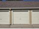 Neutral garage doors with a shingled roof at 10251 W 44Th Ave # 8-102, Wheat Ridge, CO 80033