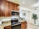 Kitchen features stainless steel appliances, wood cabinetry, and granite countertops at 10251 W 44Th Ave # 8-102, Wheat Ridge, CO 80033