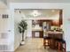 Spacious kitchen with stainless steel refrigerator, breakfast bar, and wood cabinets, offering ample storage space at 10251 W 44Th Ave # 8-102, Wheat Ridge, CO 80033