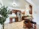 Bright kitchen showcasing a stainless steel refrigerator, ample counter space, and convenient bar stool seating at 10251 W 44Th Ave # 8-102, Wheat Ridge, CO 80033