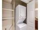 Convenient laundry closet featuring a stacked washer and dryer unit, shelving for organization at 10251 W 44Th Ave # 8-102, Wheat Ridge, CO 80033