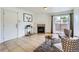 Well-lit living room featuring tile floors, a fireplace, and sliding glass doors to a balcony at 10251 W 44Th Ave # 8-102, Wheat Ridge, CO 80033