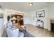 Inviting living room with tile flooring, opening to the kitchen with bar stool seating and stainless steel refrigerator at 10251 W 44Th Ave # 8-102, Wheat Ridge, CO 80033