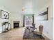 Bright living room with tile floors, a decorative fireplace, and sliding glass doors to the balcony at 10251 W 44Th Ave # 8-102, Wheat Ridge, CO 80033
