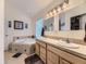 Bathroom with double sinks, large mirrors, a bathtub with tile surround, and a separate closet at 11526 Green Cir, Conifer, CO 80433