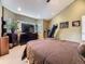 Bedroom with a bed, TV on top of a cabinet, a treadmill, and a window with blinds at 11526 Green Cir, Conifer, CO 80433