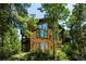 Attractive wood home featuring large windows and wooded surroundings, offering a serene mountain living experience at 11526 Green Cir, Conifer, CO 80433