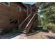 Exterior view of a cabin featuring a staircase leading to the entrance at 11526 Green Cir, Conifer, CO 80433