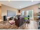 Spacious living room featuring tile flooring, a large screen, a fireplace, and a leather sofa at 11526 Green Cir, Conifer, CO 80433