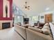 Inviting living room with fireplace, soaring ceilings, large windows with views, and plush sectional sofa at 11526 Green Cir, Conifer, CO 80433