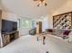 Comfortable living area featuring large windows with exterior views, tv and cozy seating at 11526 Green Cir, Conifer, CO 80433